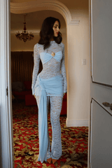 Ortigia Baby Blue by Decon Duarte – A trendy sheer stretch lace dress in soft powder blue, featuring a backless design and adjustable mini skirt. Perfect for year-round stylish occasions.