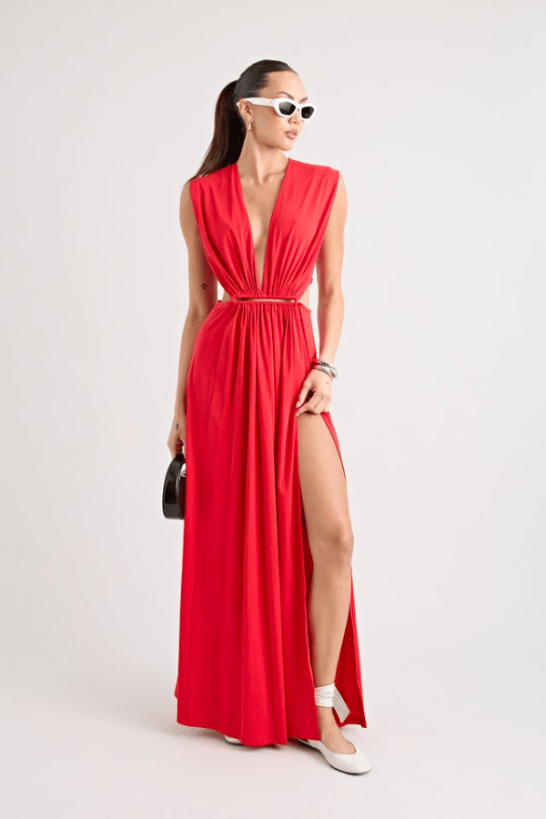 Do For Love Gown Red by Pfeiffer – A trendy low plunge maxi gown with bold hardware and thigh-high split, perfect for turning heads at special occasions.