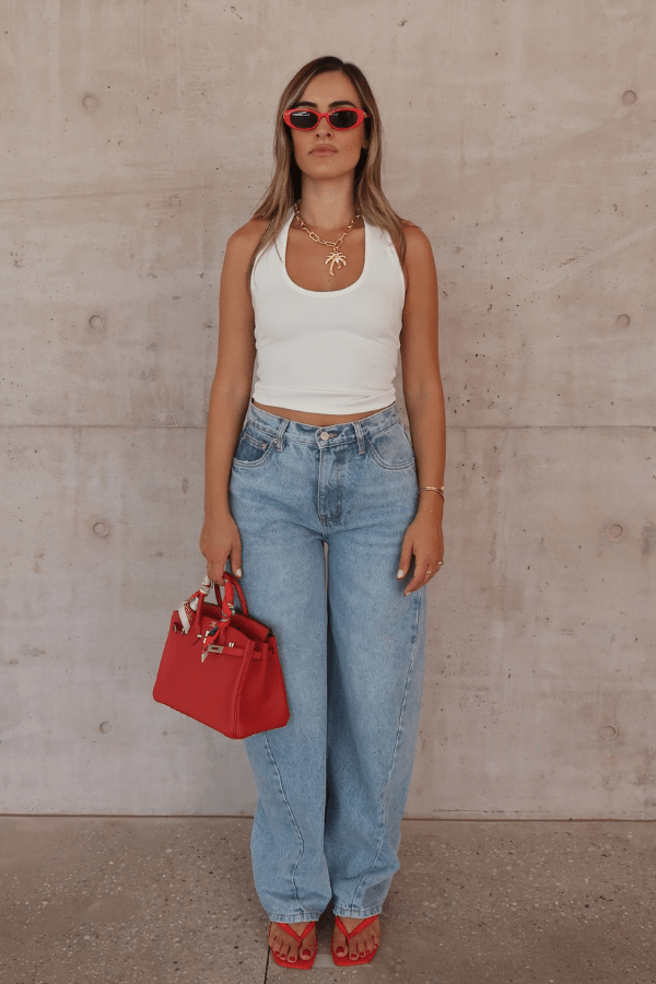 Bella Halter Tank White by Sneaky Link – Soft cotton-spandex blend with a deep scoop neckline, open back, and supportive halter design. Perfect for layering or solo wear.