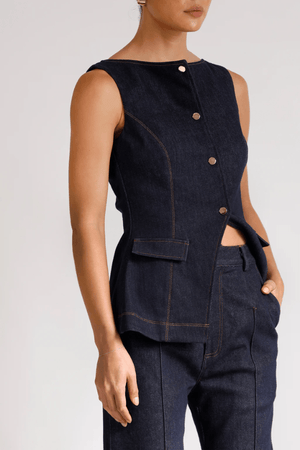Good Vibes Top Indigo by Pasduchas – Trendy stretch denim with structured fit, gold snap studs, and mock pockets; perfect for chic, coordinated looks.