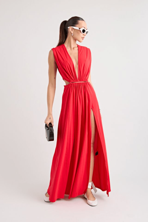 Do For Love Gown Red by Pfeiffer – A trendy low plunge maxi gown with bold hardware and thigh-high split, perfect for turning heads at special occasions.