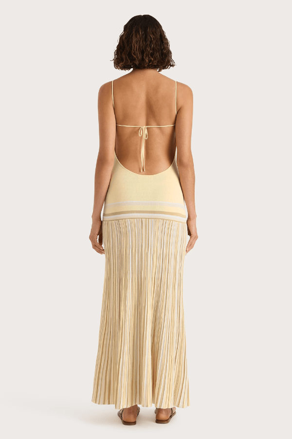 Citara Maxi Dress Butter Stripe by Faithfull the Brand – Trendy ribbed knit maxi with adjustable straps and backless tie, perfect for effortless summer elegance and beach days.