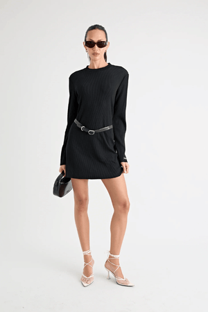 Fairbank Rib Dress Black by Pfeiffer – A trendy, comfortable ribbed bamboo dress with high raw-edge neckline, full sleeves, and versatile two-part back design. Perfect for chic casual wear or layering in cooler seasons.