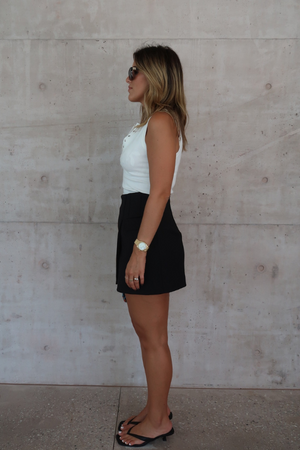 Sneaky Mini Skirt Black by Sneaky Link – A-line high-waisted mini with boned waist and flap pockets, perfect for day-to-night styling.