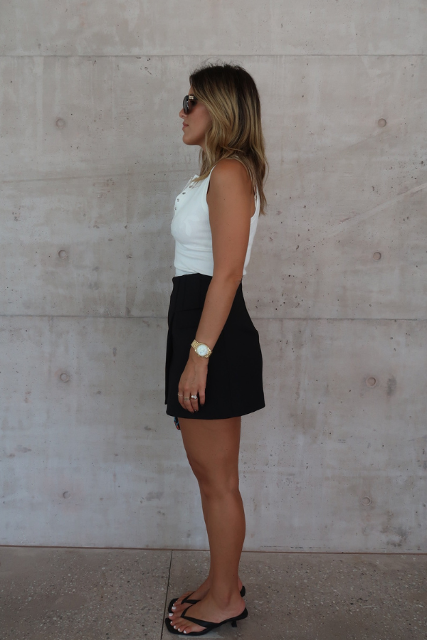 Sneaky Mini Skirt Black by Sneaky Link – A-line high-waisted mini with boned waist and flap pockets, perfect for day-to-night styling.