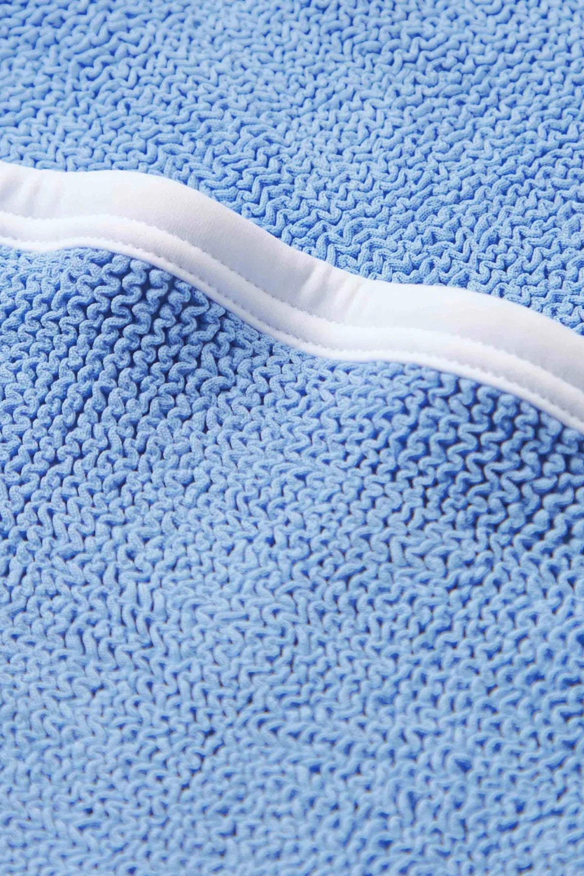 Devyn Swimskirt by Hunza G, a crinkle-textured piece worn as a tube top or skirt. Perfect for beach layering or versatile summer styling.