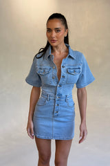 Katrina Denim Mini Dress in Light Blue Wash by Sneaky Link, stretch denim dress with cinched waist and button-up front.