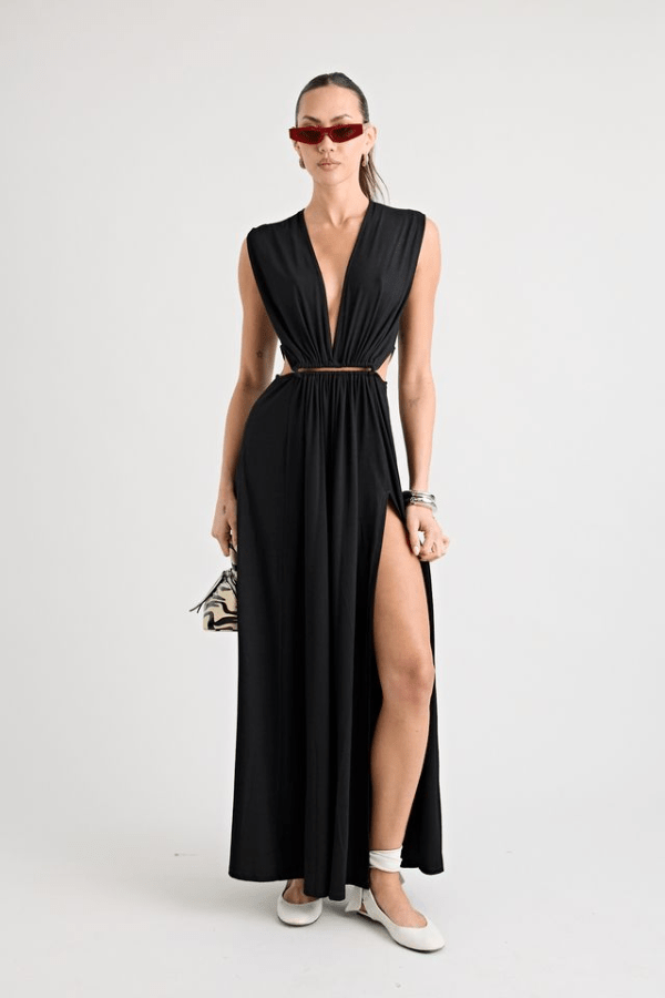 Do For Love Gown Black by Pfeiffer – A trendy, elegant low-plunge maxi with bold hardware and thigh-high split, perfect for special occasions and modern sophistication.