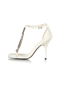 Abel Heel by Alias Mae, a bone leather stiletto with metal T-bar detail and ankle strap. Perfect for weddings or night events.