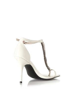 Abel Heel by Alias Mae, a bone leather stiletto with metal T-bar detail and ankle strap. Perfect for weddings or night events.