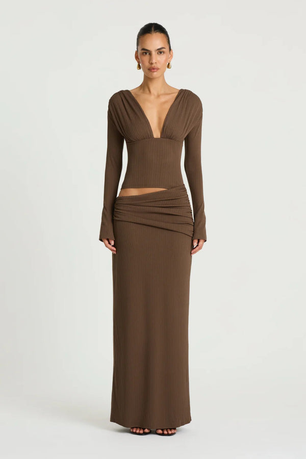 Agnes Maxi Dress in Chocolate by Benni, a ribbed long-sleeve maxi with deep plunge neckline, gathered bust, and subtle hip draping.