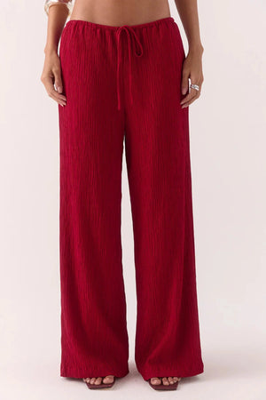 Aine Pants in Raspberry by Sovere – mid-rise crinkle pants with drawstring waist and pockets. Perfect for relaxed, effortless styling.