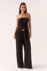 Aine Top Black by Sovere – a strapless crinkle top with pleated waist and asymmetric hem. Perfect for summer styling.