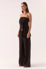 Aine Top Black by Sovere – a strapless crinkle top with pleated waist and asymmetric hem. Perfect for summer styling.