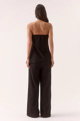 Aine Top Black by Sovere – a strapless crinkle top with pleated waist and asymmetric hem. Perfect for summer styling.