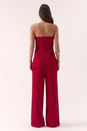 Aine Top in Raspberry by Sovere – strapless crinkle top with pleated waist and asymmetric hem. Perfect for bold, warm-weather looks.