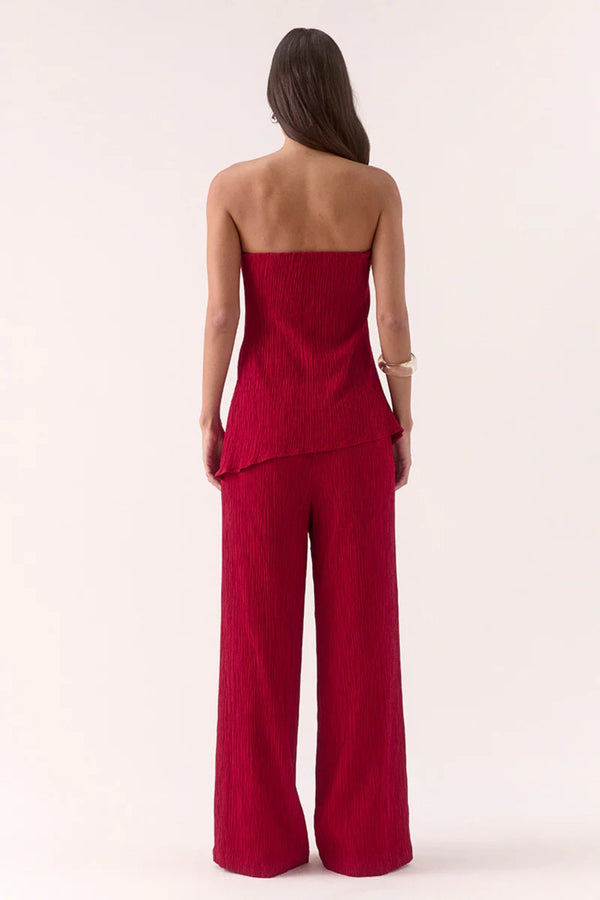 Aine Top in Raspberry by Sovere – strapless crinkle top with pleated waist and asymmetric hem. Perfect for bold, warm-weather looks.