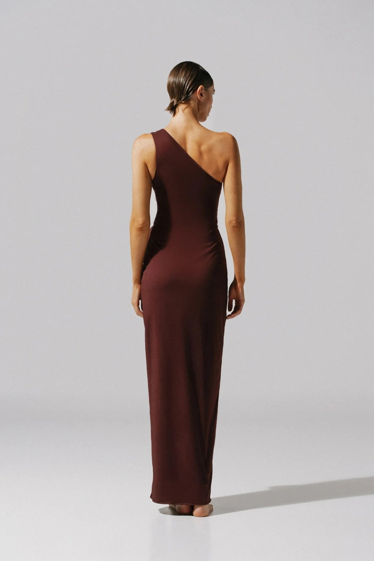 Allende Maxi Dress by Baobab, a one-shoulder gown with ring detail, asymmetrical hem, and side slit. Ideal for elegant evenings.