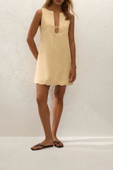 Alondra Mini Dress Daffodil by Faithfull the Brand – a linen mini dress with tie detail and scalloped hem. Perfect for sunny days.