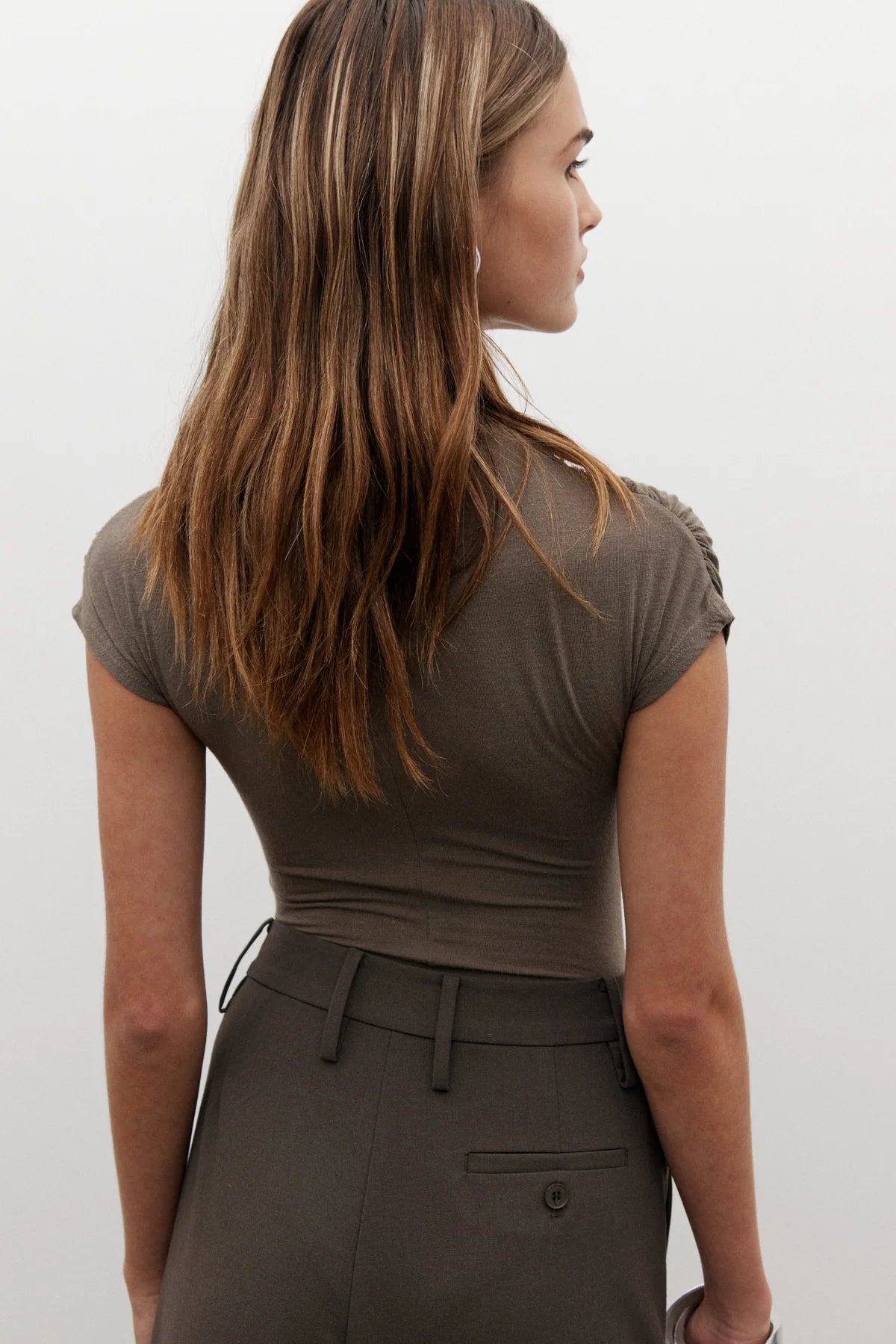 Amrita Sleeveless Bodysuit in Mink by Bayse, crafted from a soft stretch-knit blend for a sleek, comfortable fit. Ideal for layering.
