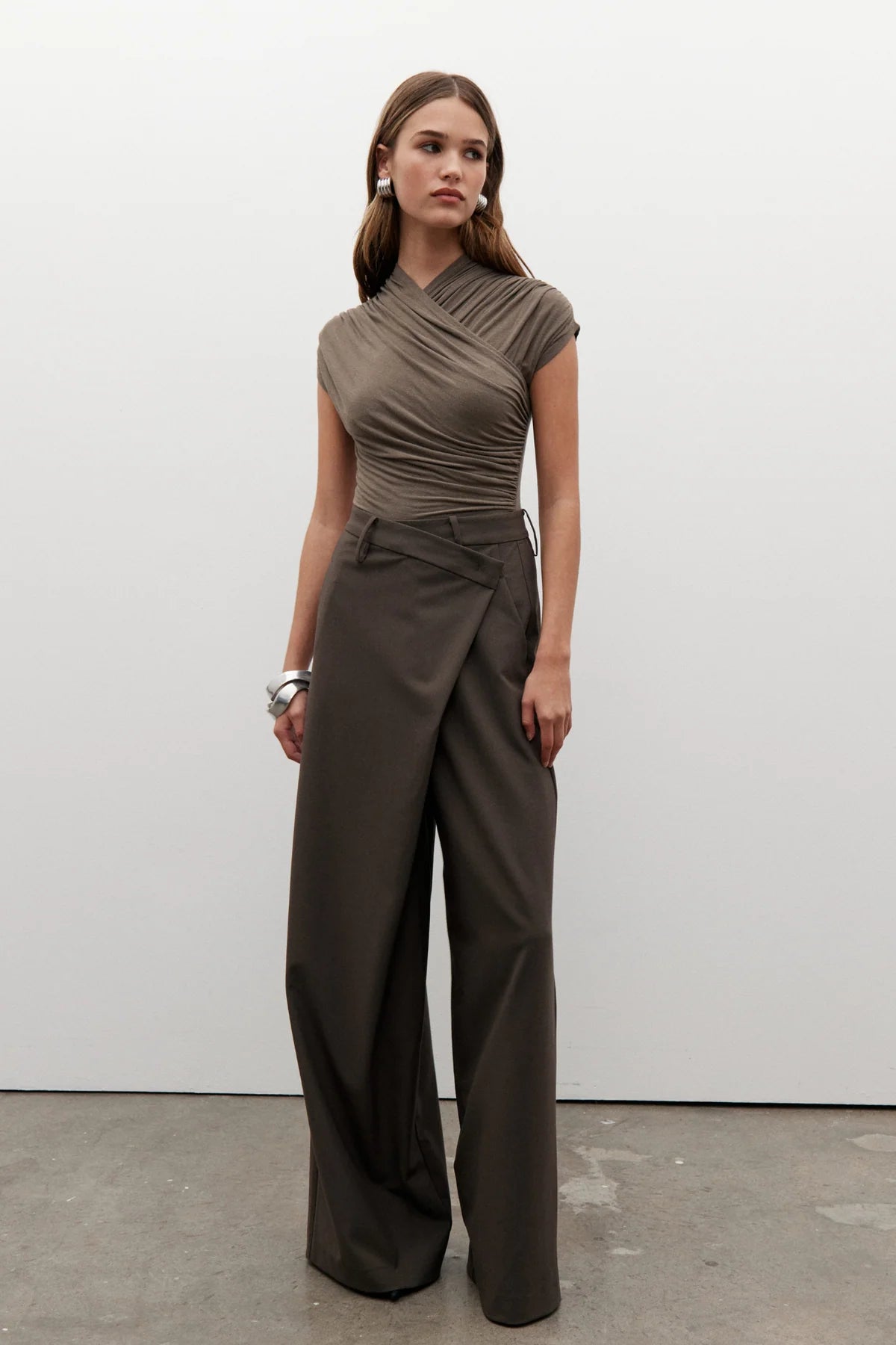 Amrita Sleeveless Bodysuit in Mink by Bayse, crafted from a soft stretch-knit blend for a sleek, comfortable fit. Ideal for layering.
