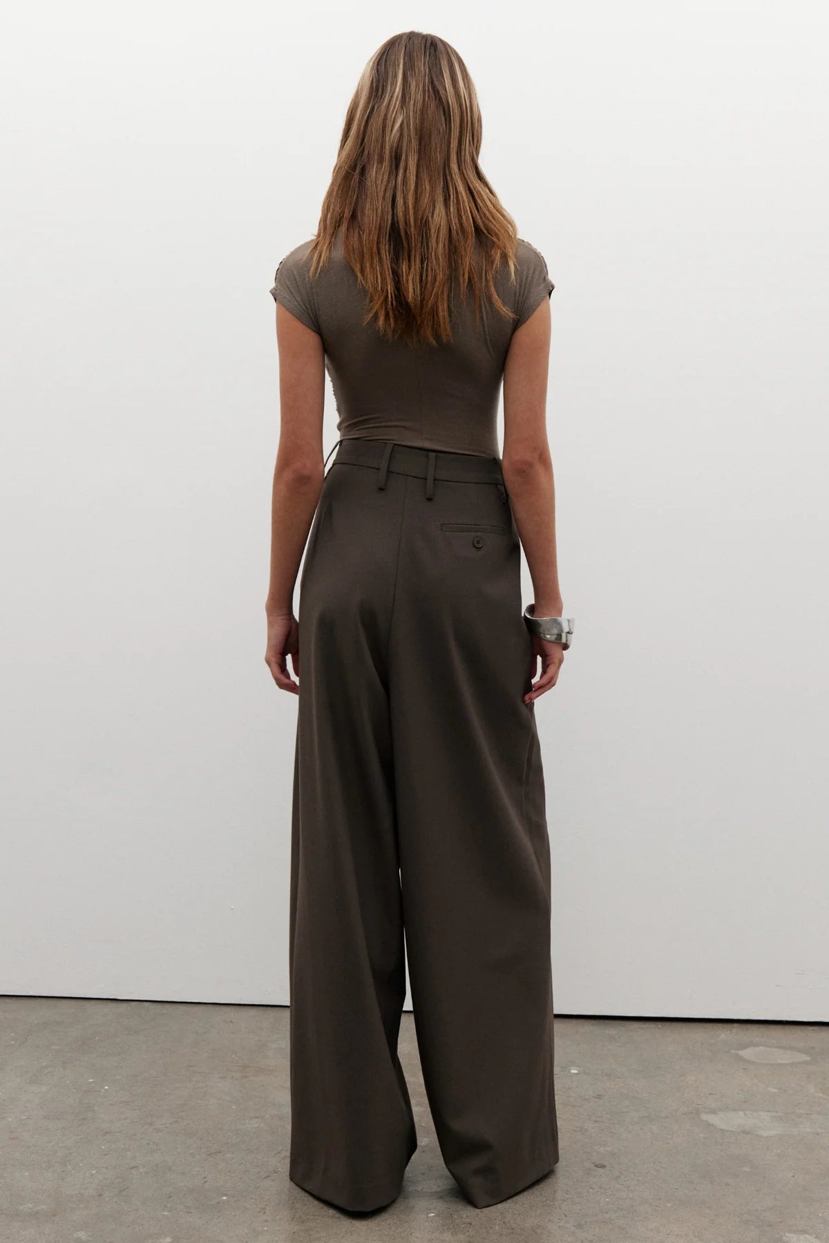 Amrita Sleeveless Bodysuit in Mink by Bayse, crafted from a soft stretch-knit blend for a sleek, comfortable fit. Ideal for layering.
