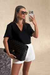 Anna Top Black by Sneaky Link – a cropped boxy top with V neckline and structured fit. Perfect for modern everyday styling.