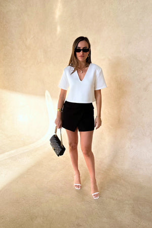 Anna Top in White by Sneaky Link, a cropped V-neck silhouette in crisp cotton blend. Perfect for clean, modern styling.
