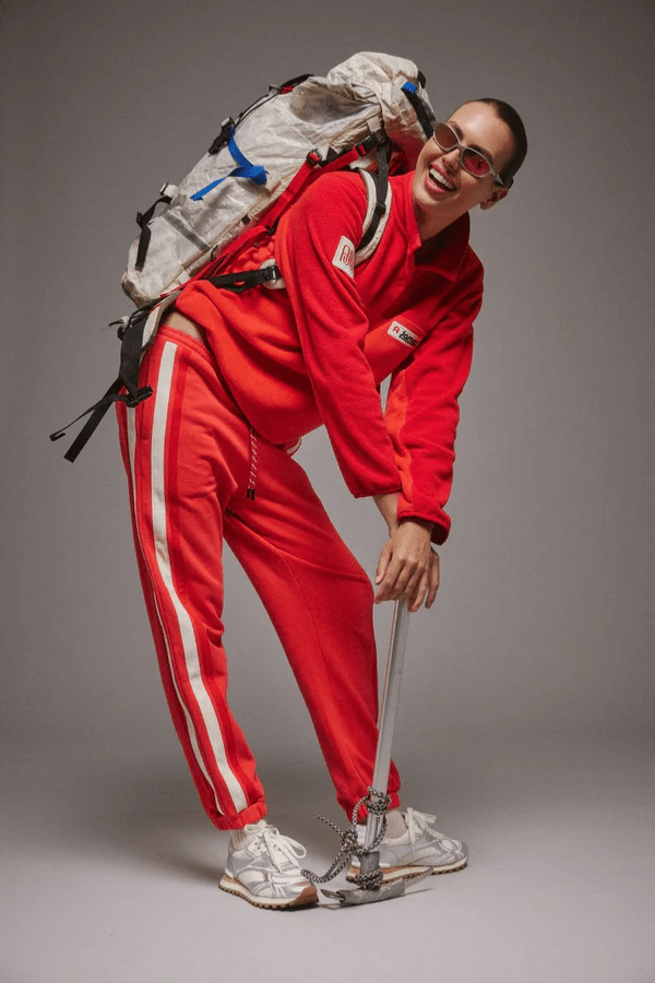 Bisous Trackpant Coral by Araminta James, features a relaxed fit with tapered leg, soft brushed fleece fabric, elasticized waistband with drawcord, side pockets, elastic cuffs, and contrast side trims.