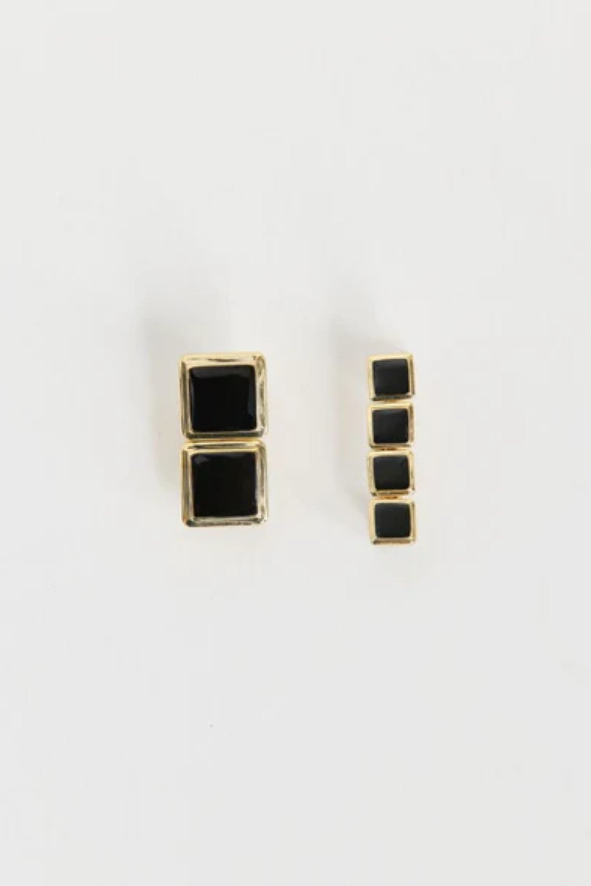 Archer Drop Earrings in Gold – mismatched gold PVD-plated earrings with black enamel drops, perfect for sleek day-to-night styling.