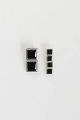 Archer Drop Earrings in Silver – mismatched silver PVD-plated earrings with black enamel drops, perfect for sleek day-to-night styling.