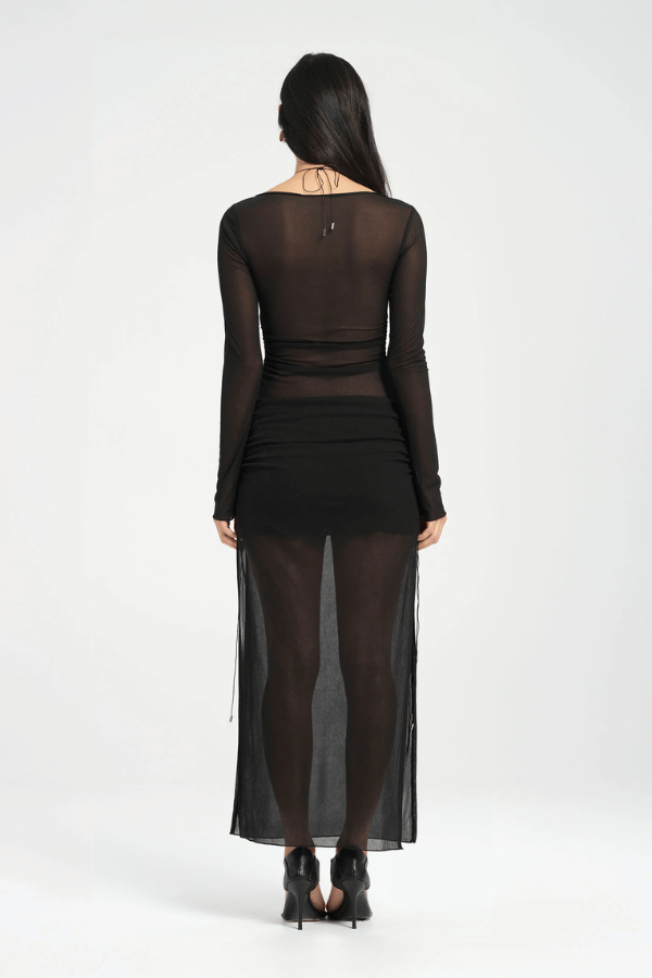 Ari Cutaway Dress Black by Benni – A viral, sleek maxi with dramatic geometric cut-outs and adjustable leg slits, perfect for bold, glamorous nights.