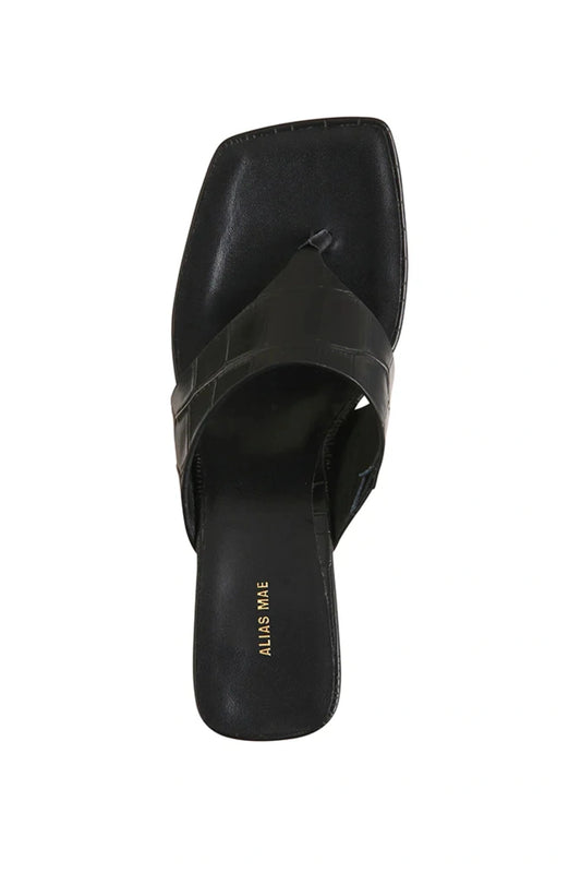 Aria Bone Oil Leather by Alias Mae, leather thong sandal with stud accents and curved heel, a trendy piece perfect for summer or refined styling.