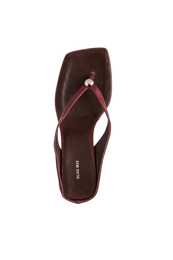 Aria Burgundy Oily Leather by Alias Mae, thong sandal with stud accents and 6cm curved heel, a trendy piece perfect for everyday chic or evenings out.