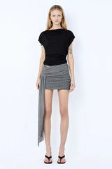 Astra Drape Mini Skirt by Bec + Bridge, a shimmering embellished knit mini with asymmetric gathers and a draped sash—perfect for chic summer styling.
