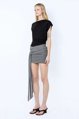 Astra Drape Mini Skirt by Bec + Bridge, a shimmering embellished knit mini with asymmetric gathers and a draped sash—perfect for chic summer styling.