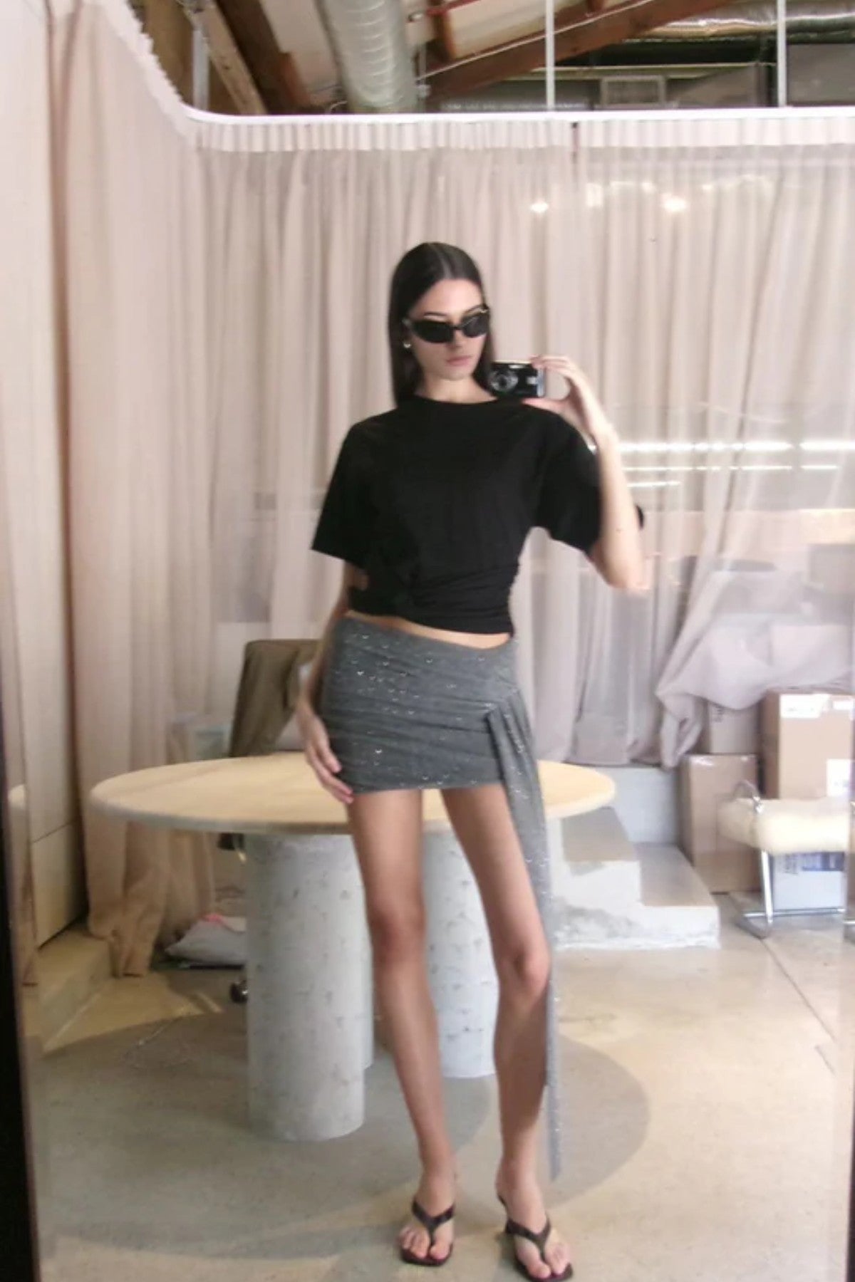 Astra Drape Mini Skirt by Bec + Bridge, a shimmering embellished knit mini with asymmetric gathers and a draped sash—perfect for chic summer styling.