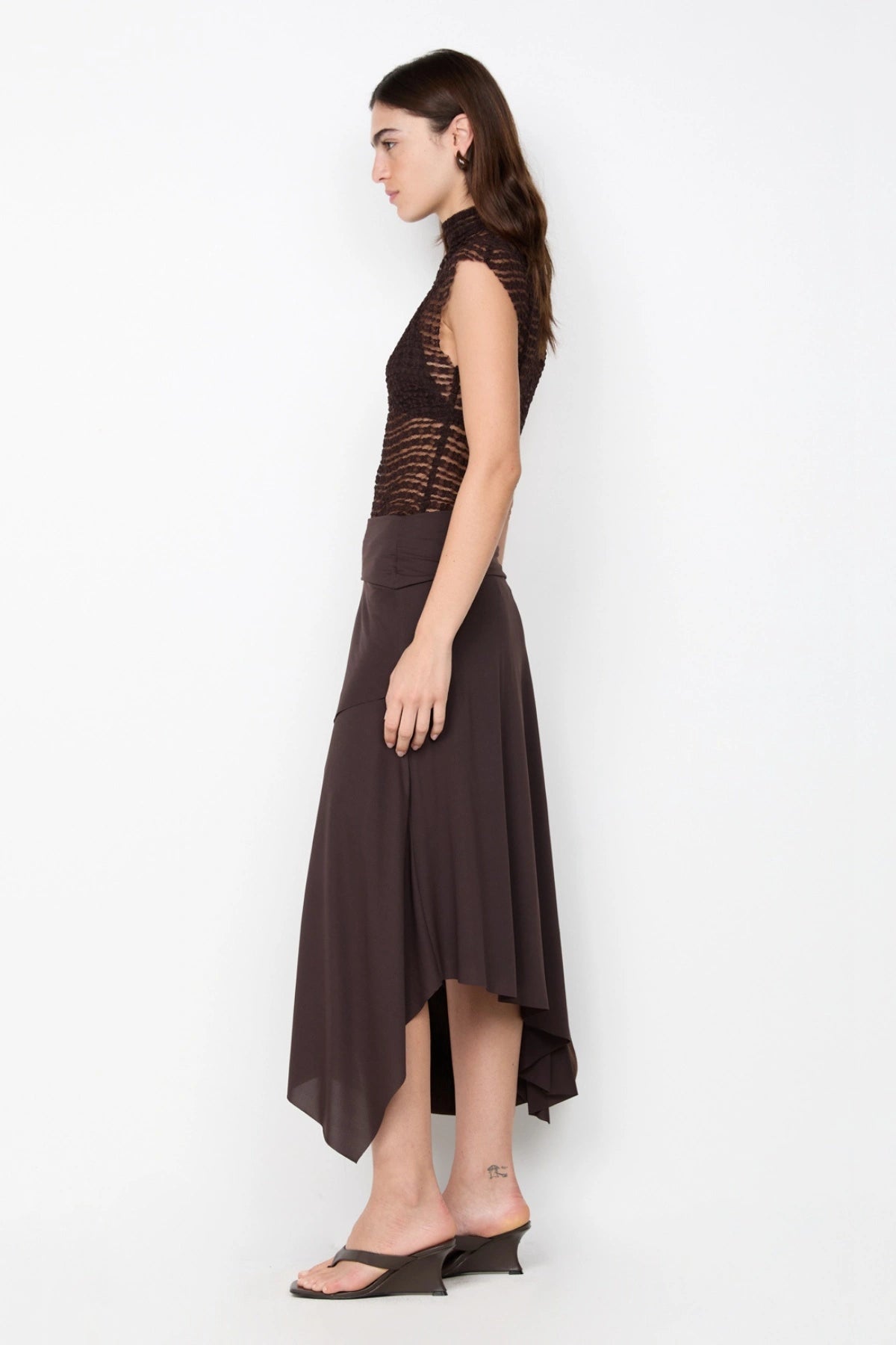 Asym Midi Skirt in Dark Chocolate by Bec + Bridge, designed with a draped silhouette and asymmetric hem for an effortlessly chic look.