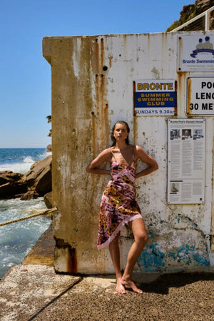 Asym Siren Orchid by Summi Summi – asymmetrical fitted dress with vibrant print and lace detailing for elevated evening styling.