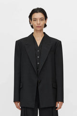 Aya Wool Blazer by Camilla and Marc in black, oversized draped silhouette with cream fleck texture and tailored detailing.

