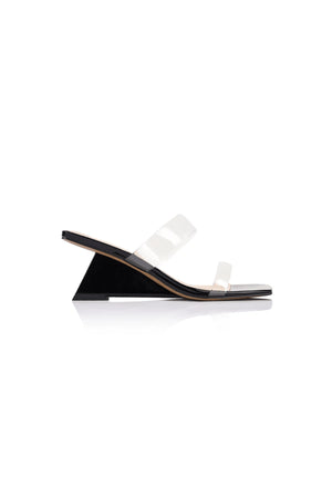Bambi Wedge in Black Patent Leather by Lana Wilkinson, a sculptural mule with clear straps, 6.5cm wedge, and square toe for modern minimalism.