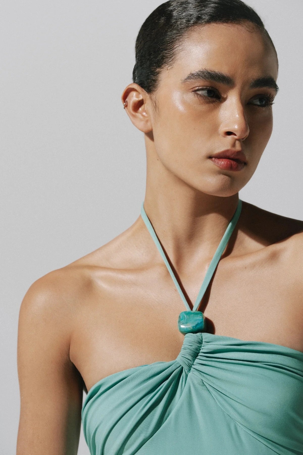 Bari Maxi Dress by Baobab, a shimmering halter gown with resin stones, side slit, and open back. Perfect for elegant summer nights.