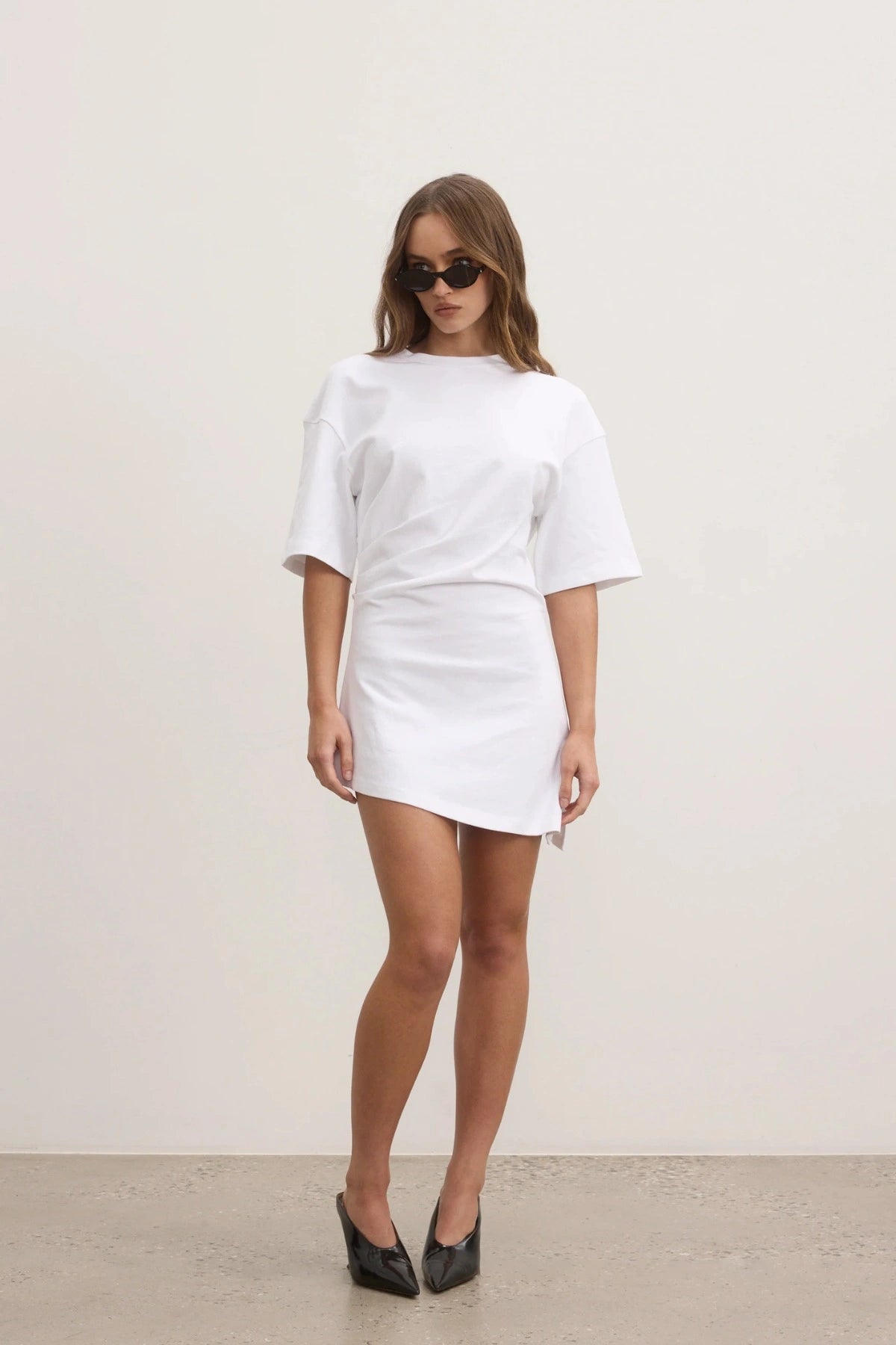 Bayse Joanna Dress in White, a relaxed cotton t-shirt dress with dropped shoulders and asymmetric hemline for everyday ease.
