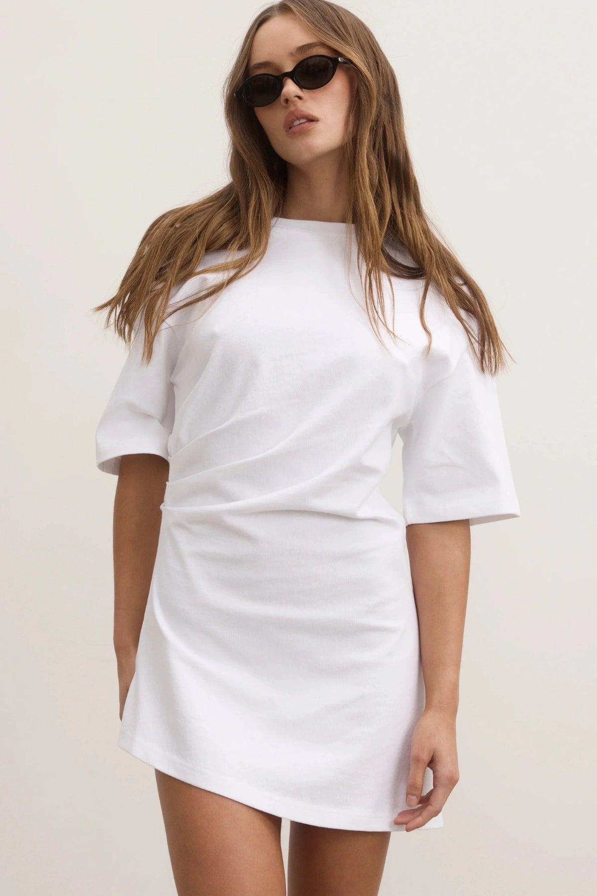 Bayse Joanna Dress in White, a relaxed cotton t-shirt dress with dropped shoulders and asymmetric hemline for everyday ease.
