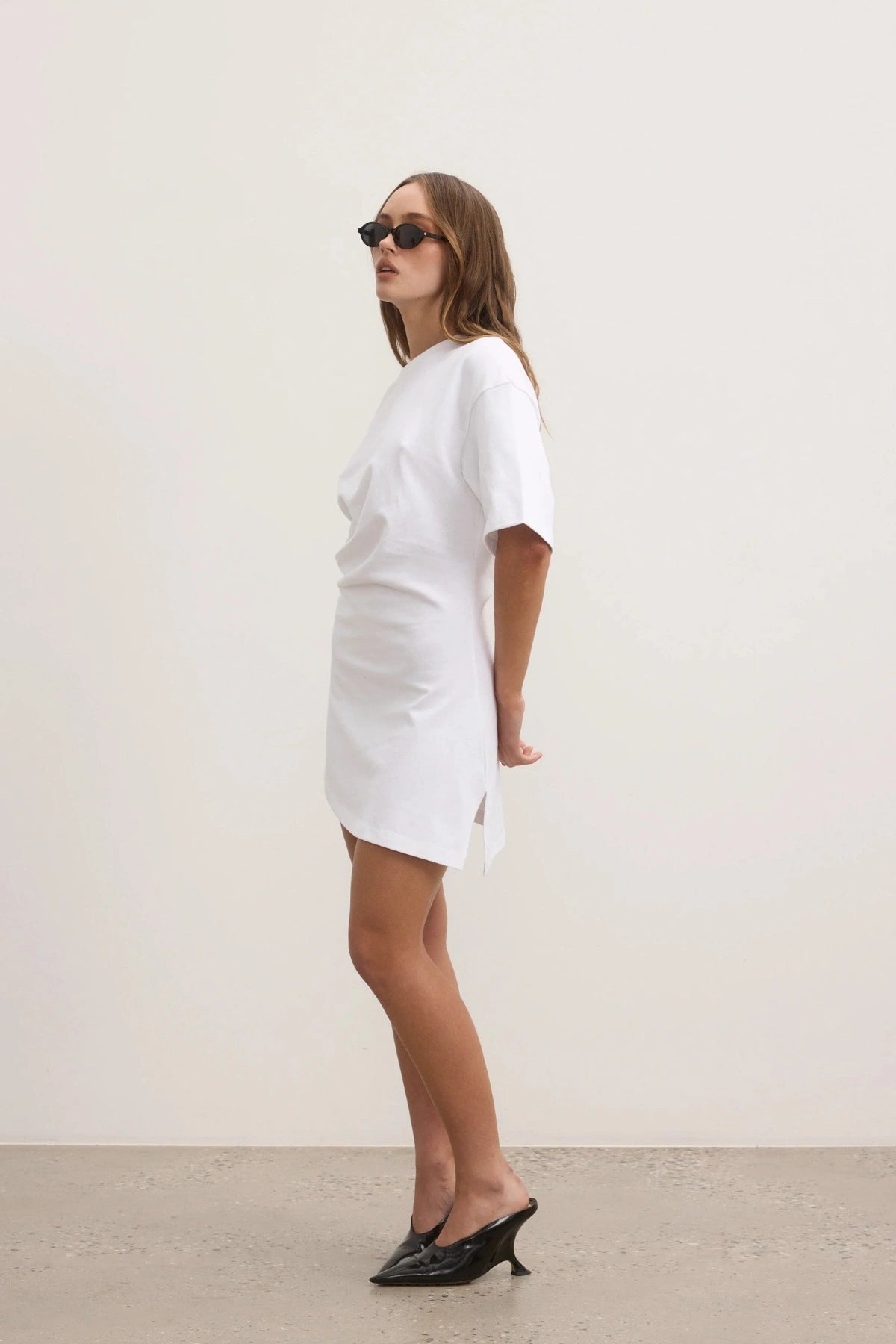 Bayse Joanna Dress in White, a relaxed cotton t-shirt dress with dropped shoulders and asymmetric hemline for everyday ease.

