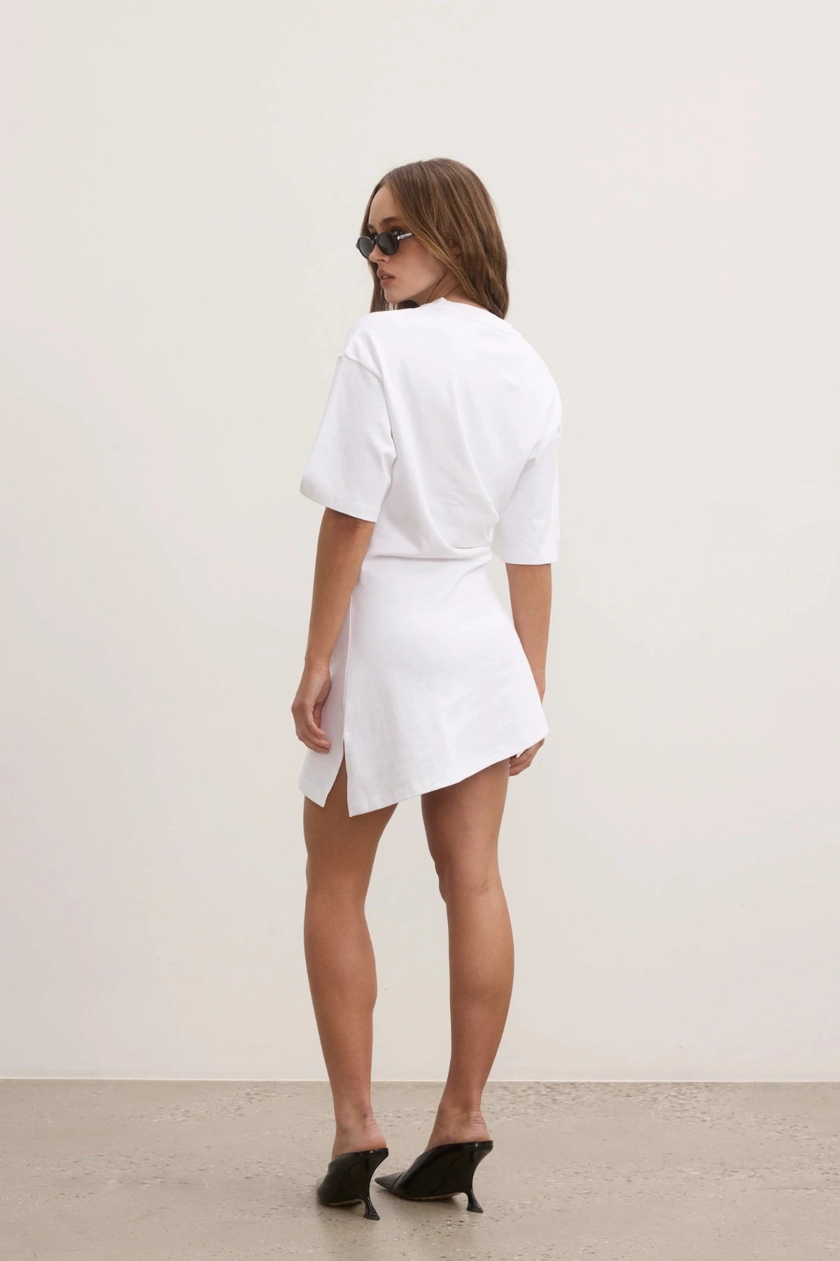 Bayse Joanna Dress in White, a relaxed cotton t-shirt dress with dropped shoulders and asymmetric hemline for everyday ease.

