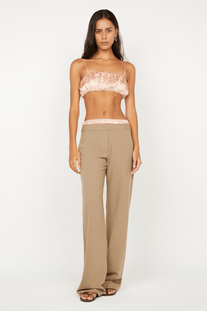 Jai Bandeau in Peach by Bec + Bridge, a washed silk strapless top with adjustable straps and picot edging for a chic day-to-night look.