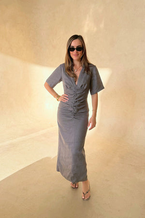 Belle Midi Dress in Steel by Sneaky Link, crafted from breathable linen with ruched shaping and arm coverage. Perfect for warm-weather elegance.
