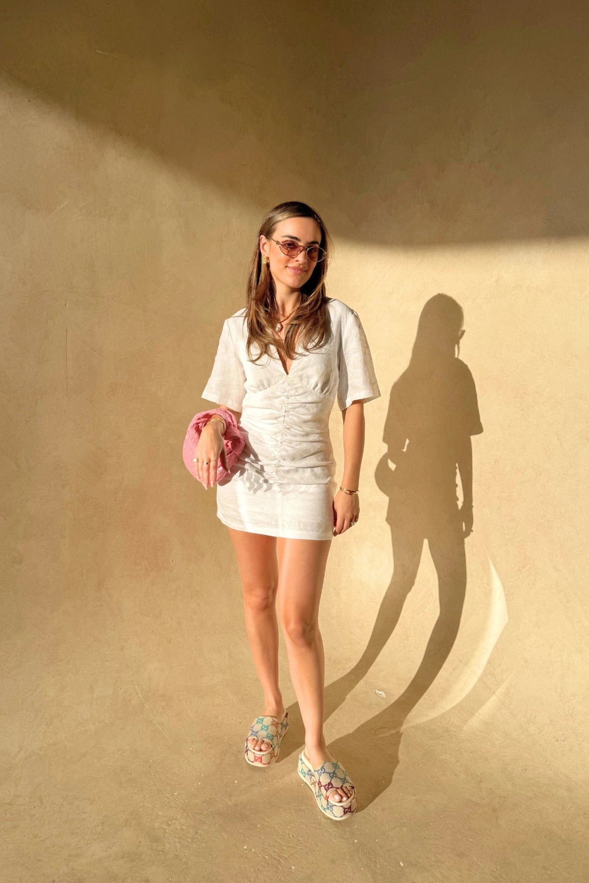 Belle Mini Dress in White by Sneaky Link, crafted from crisp linen with ruched shaping and arm coverage. Perfect for fresh summer days.
