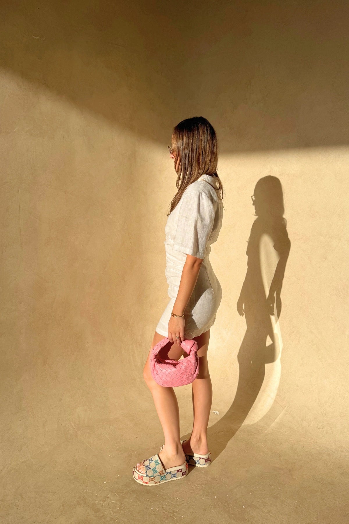 Belle Mini Dress in White by Sneaky Link, crafted from crisp linen with ruched shaping and arm coverage. Perfect for fresh summer days.
